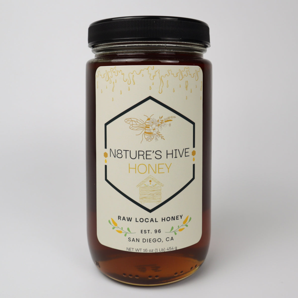 Jar of Nature's Hive honey with a label on a white background