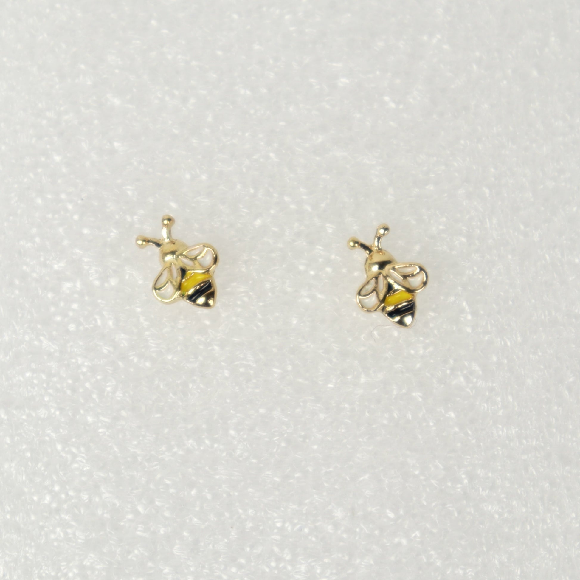 Gold bee-shaped earrings on a white background