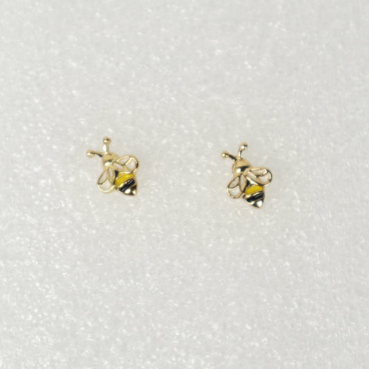 Gold bee-shaped earrings on a white background